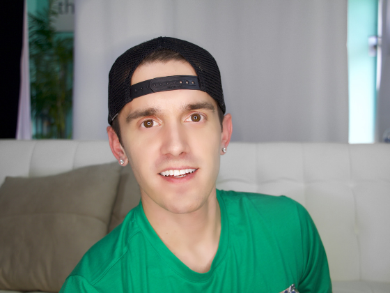 Image: Josh Robbins wearing a green shirt and a backwards cap
